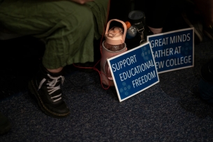 Student signs for "educational freedom" at New College of Florida.